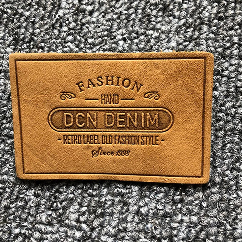 Юқори сифатли махсус логотип кабартмалı ПУ ёрлиғи ямоқлари ёрлиғи Тери ямоқ кийим аксессуарлари Жинси шимлар учун тери ёрлиғи