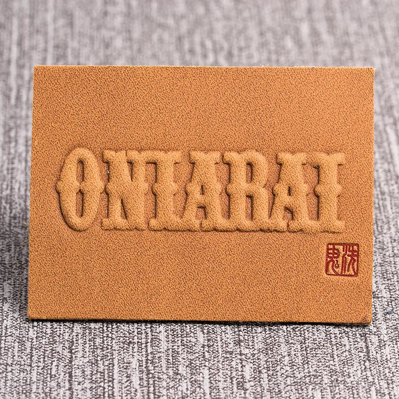 Юқори сифатли махсус логотип кабартмалı ПУ ёрлиғи ямоқлари ёрлиғи Тери ямоқ кийим аксессуарлари Жинси шимлар учун тери ёрлиғи