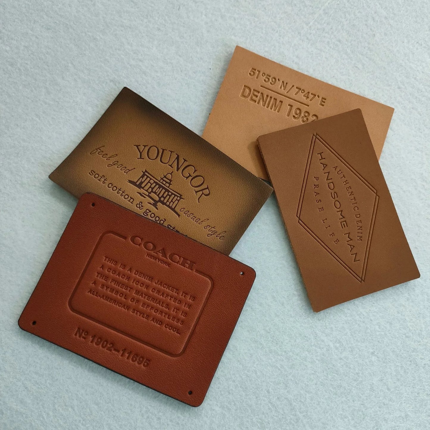 Ямалар улгуржи дизайн Махсус ном логотипи бўртма нақшли ҳақиқий чармдан ясалган ямалар ва сумкалар ва кийимлар учун ёрлиқлар Шляпалар жинси шимлар