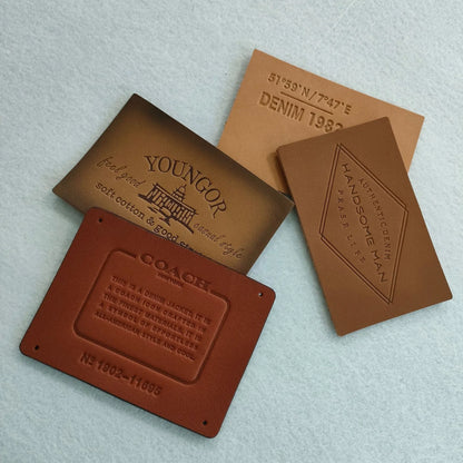 Ямалар улгуржи дизайн Махсус ном логотипи бўртма нақшли ҳақиқий чармдан ясалган ямалар ва сумкалар ва кийимлар учун ёрлиқлар Шляпалар жинси шимлар